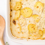 scalloped potatoes in a white casserole dish.