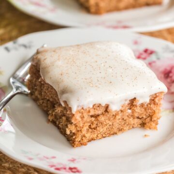 applesauce cake with cream cheese frosting on a plate.