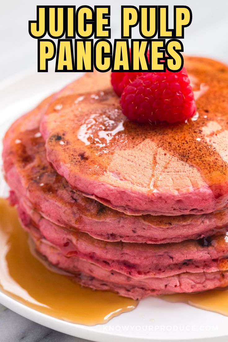 beet juice pulp pancakes that are pink stacked on a plate with syrup and a raspberry on top with text on image saying juice pulp pancakes.