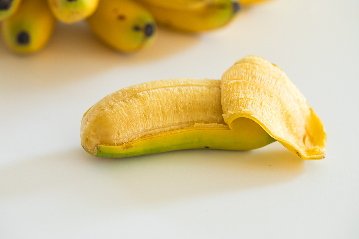 partially peeled baby banana.