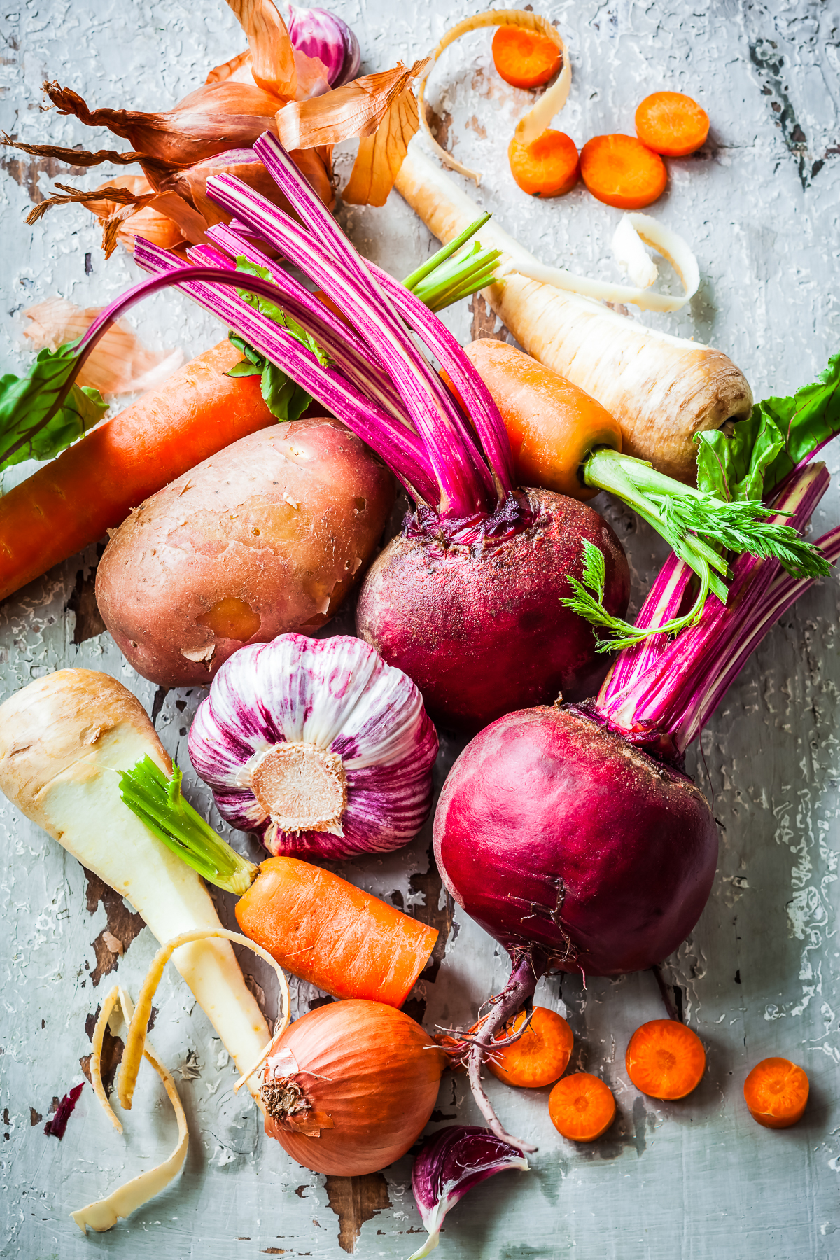 root vegetables on a gray slate backdrop overhead photo.