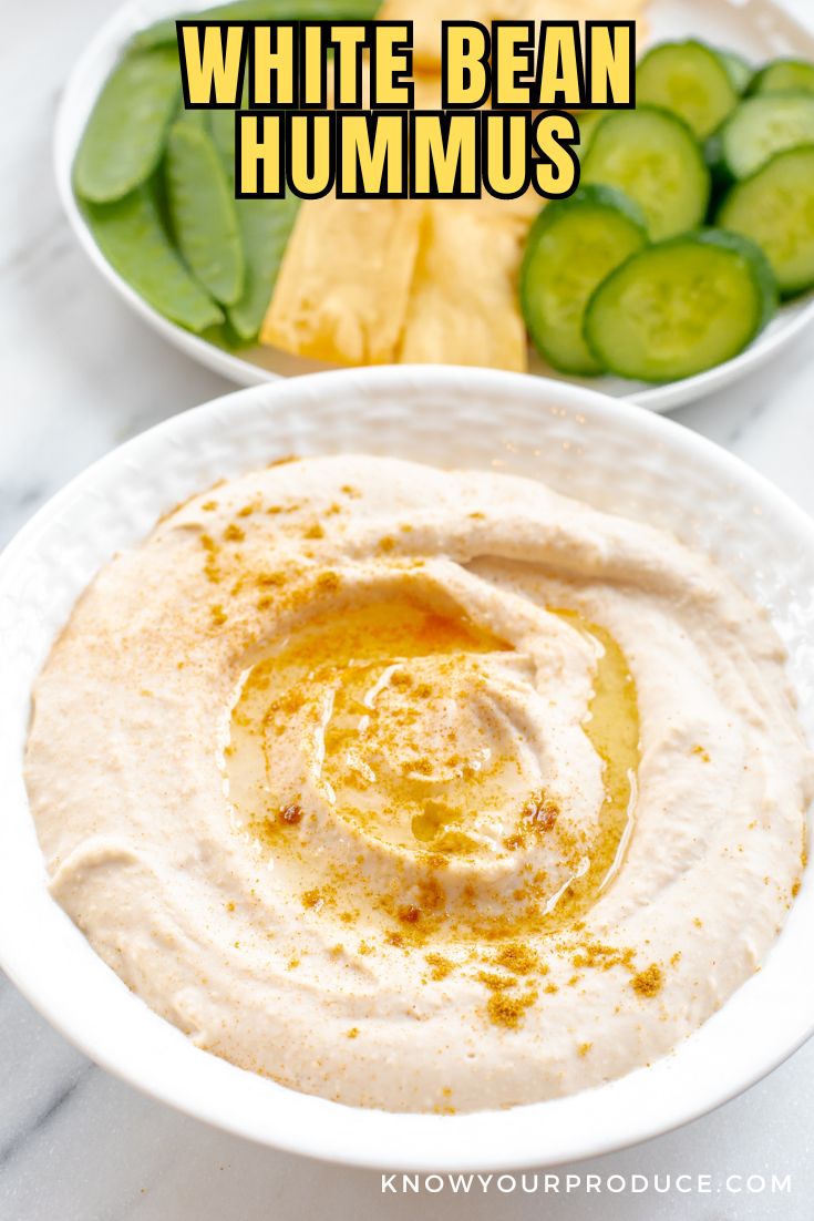 white bean hummus in a white bowl with text on image saying white bean hummus for pinterest.