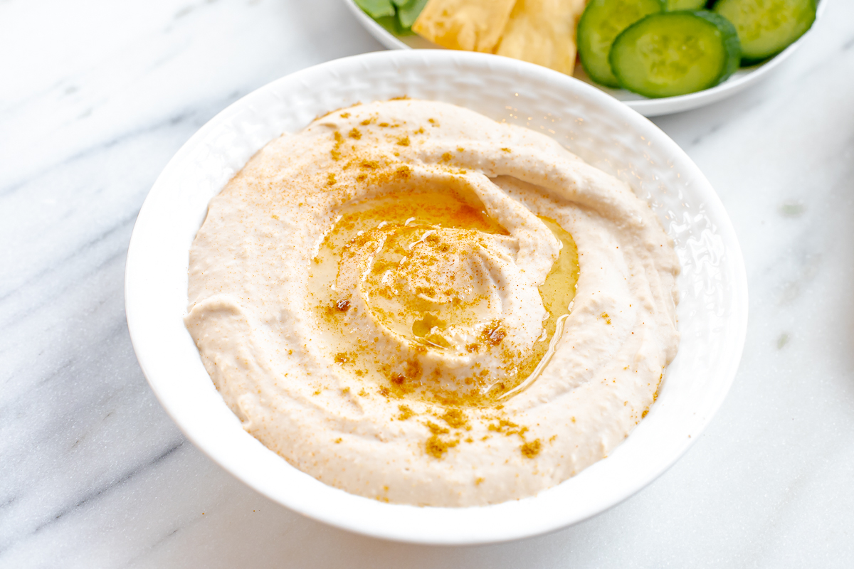 white bean hummus in a white bowl.
