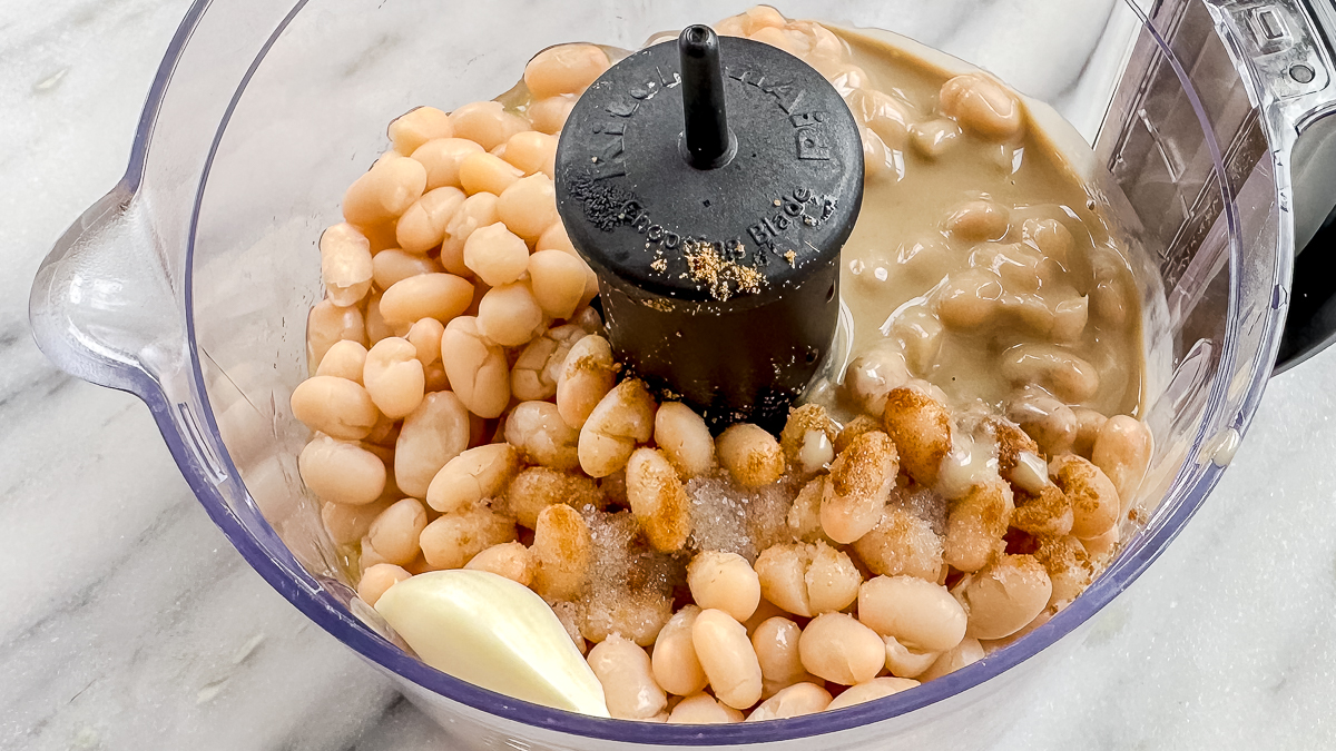 white beans, garlic, tahini, cumin, extra virgin olive oil, salt, and lemon juice in a food processor unblended.