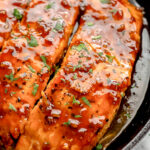 honey garlic salmon in a cast iron skillet.
