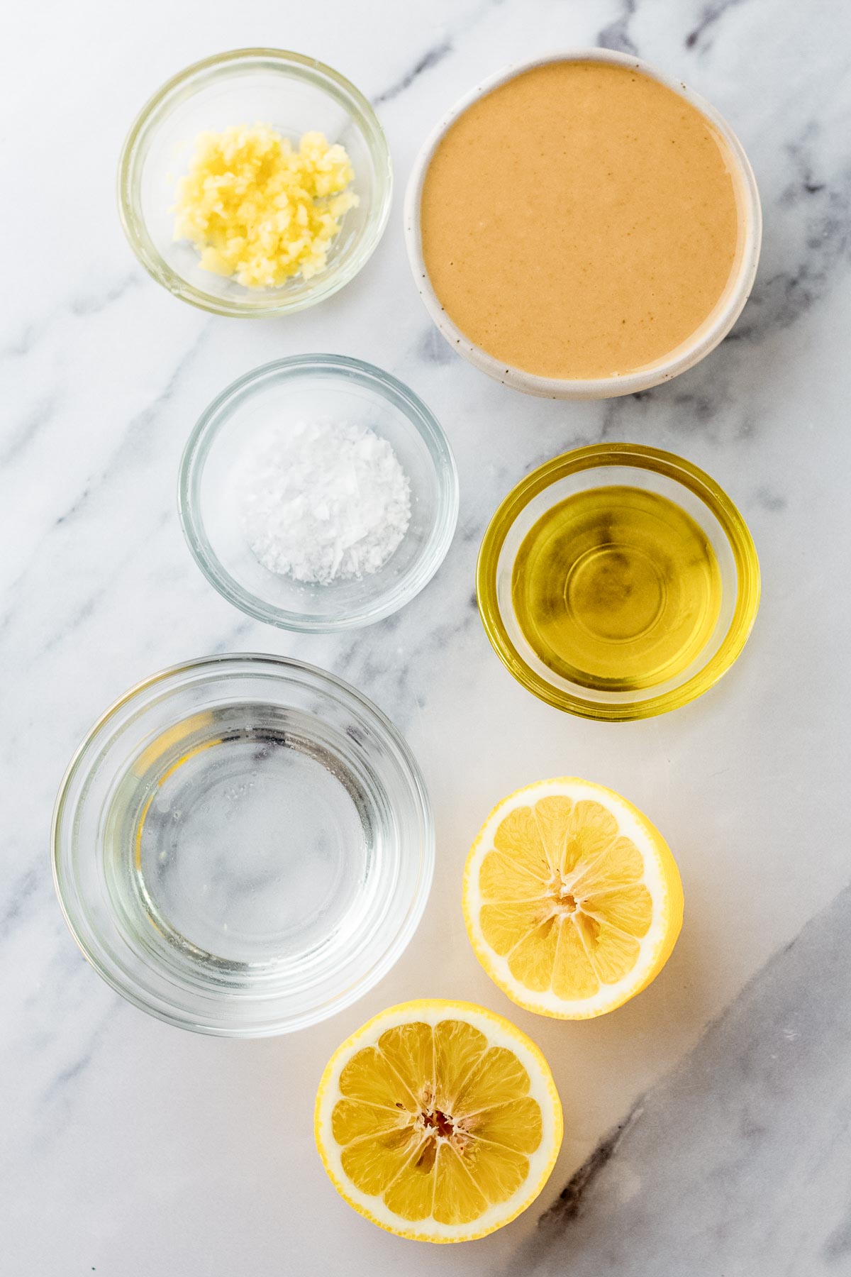 ingredients in small bowls for tahini sauce.