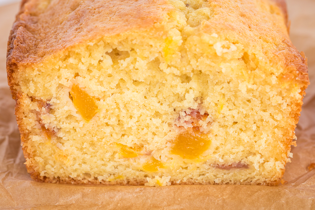 close up of peach bread showing peaches inside.