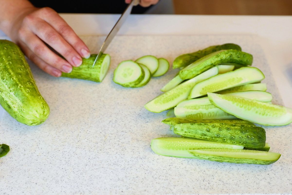 slicing cucumbers into slice and wedges for pickles.