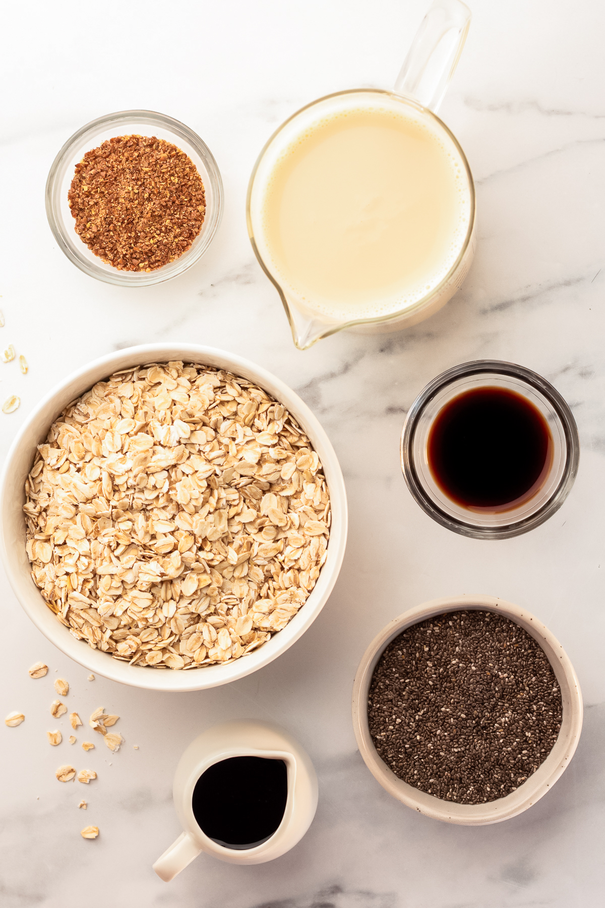 overnight oats ingredients in small bowls.