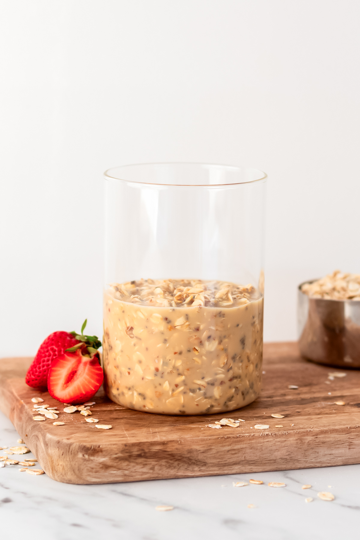 combined ingredients for overnight oats in a glass jar.