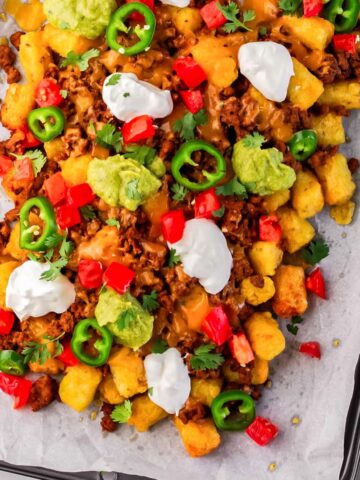 totchos on a parchment lined baking sheet.
