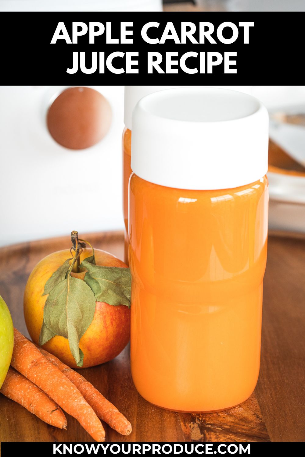 apple carrot juice in a glass bottle with apple and carrots next to it with text saying apple carrot juice.