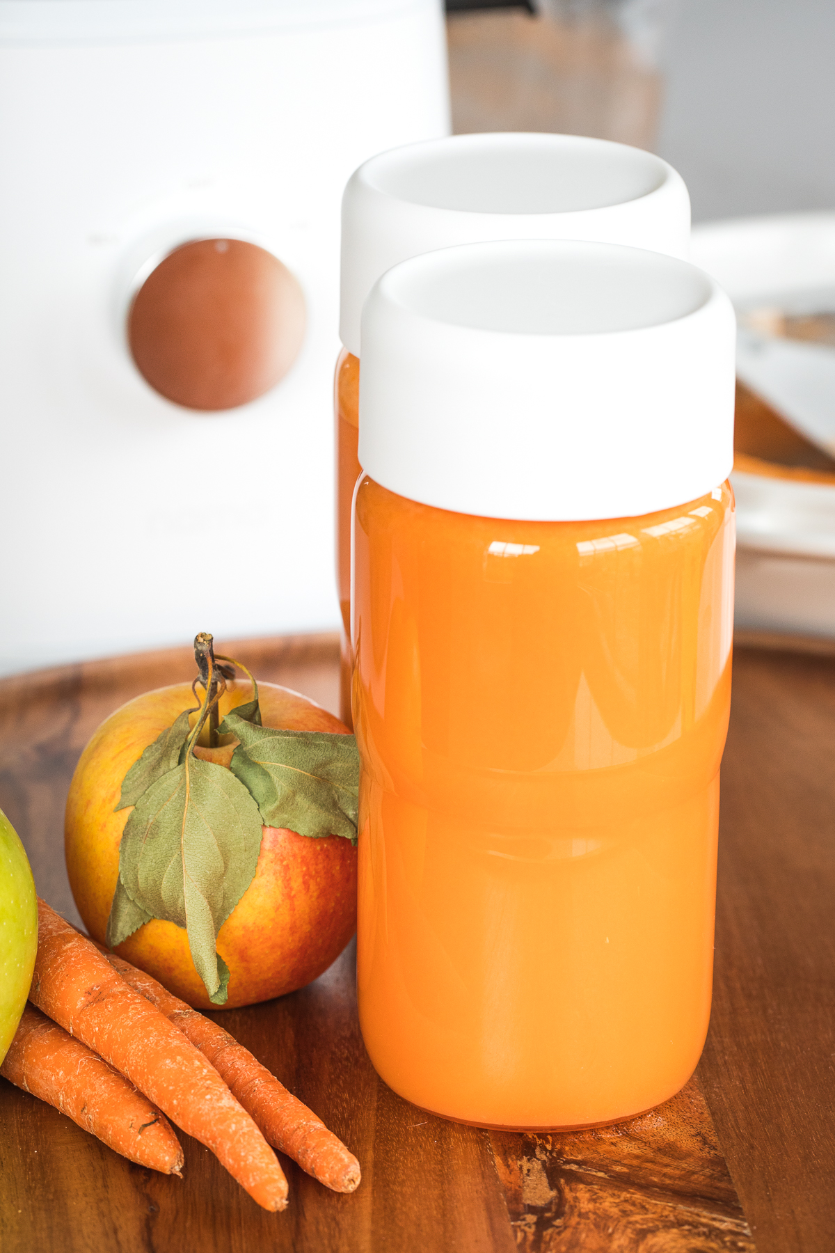 apple carrot juice in nama bottles.