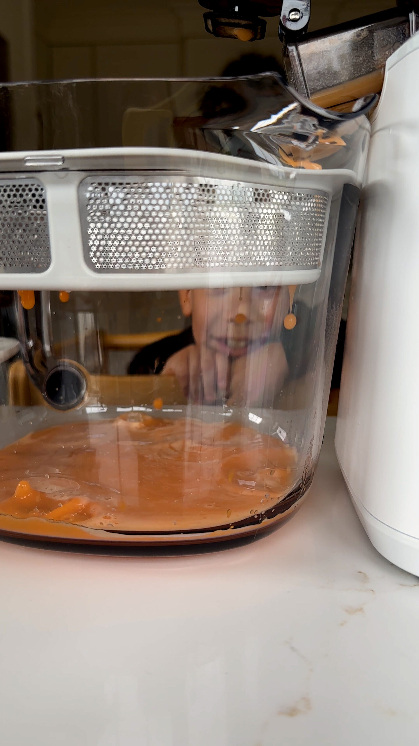 juice going into pitcher with child looking.