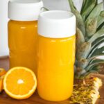 pineapple orange juice in nama juice bottles.