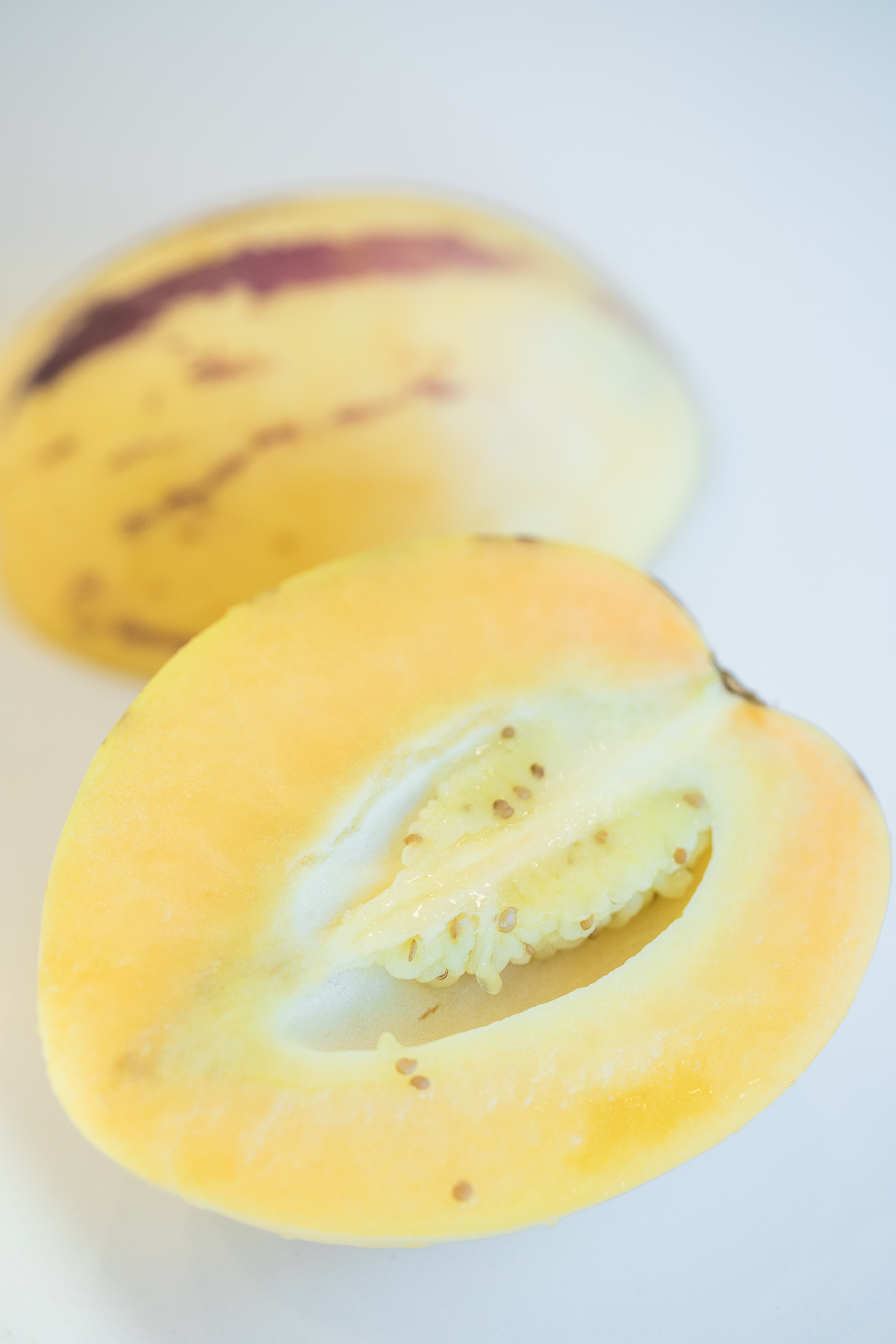 cut open pepino melon showing the inside of pepino melon.