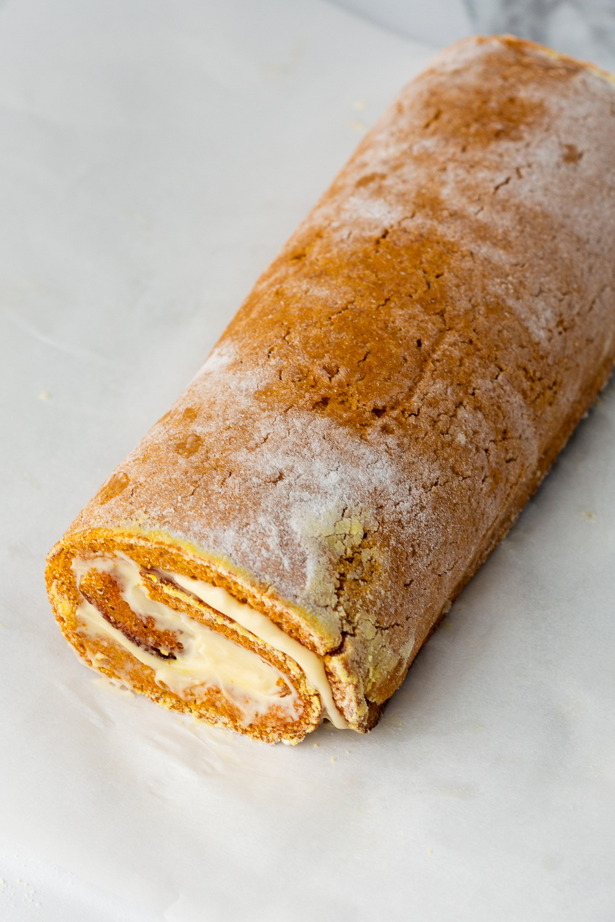 filled pumpkin roll cake rolled up.