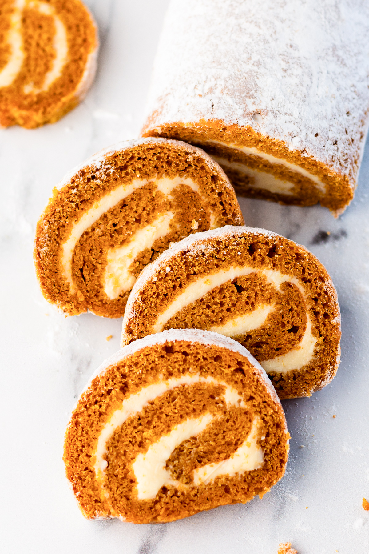 pumpkin roll sliced on a counter.